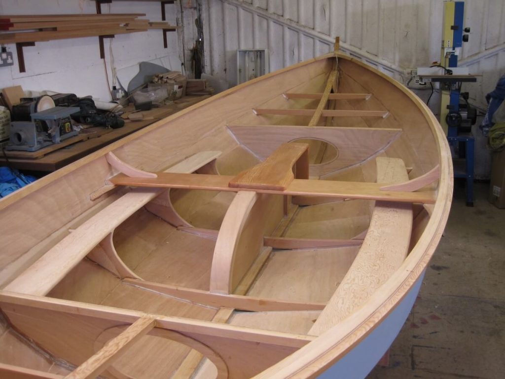 The completed hull with gunwales in place turned over and being fitted out